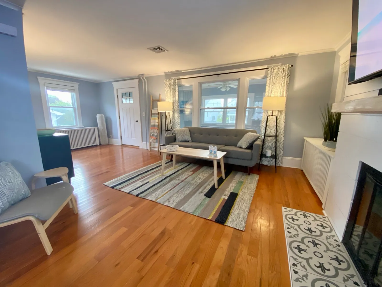 Open living room with couch and porch view